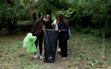 люди прибирають в парку