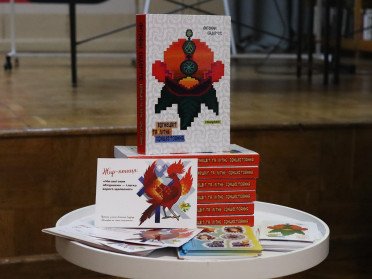 Складені на столі книги «Вогнецвіт та літнє сонцестояння».