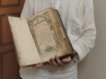 людина тримає книгу в руках