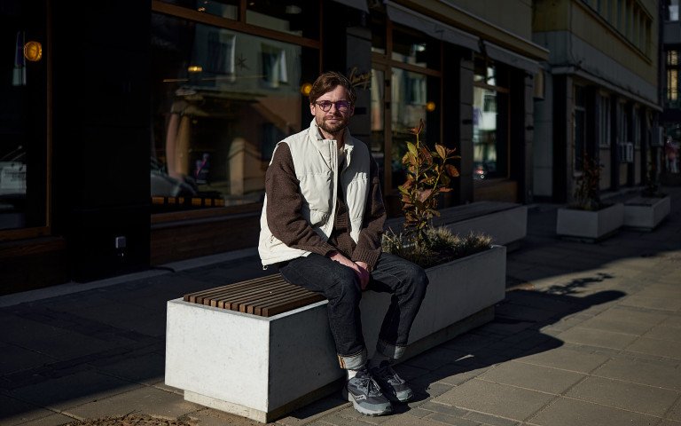 Чоловік сидить на лавці